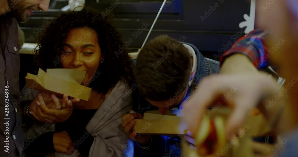 Portrait of smiling friends having fun and enjoying snacks and drinks near food truck outdoors. 4K UHD RAW Graded footage Portrait of smiling friends having fun and enjoying snacks and drinks near food truck outdoors. 4K UHD RAW Graded footage