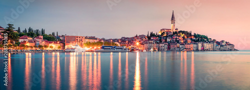 Incredible spring sunset of Rovinj town, Croatian fishing port on the west coast of the Istrian peninsula. Colorful evening seascape of Adriatic Sea. Traveling concept background.