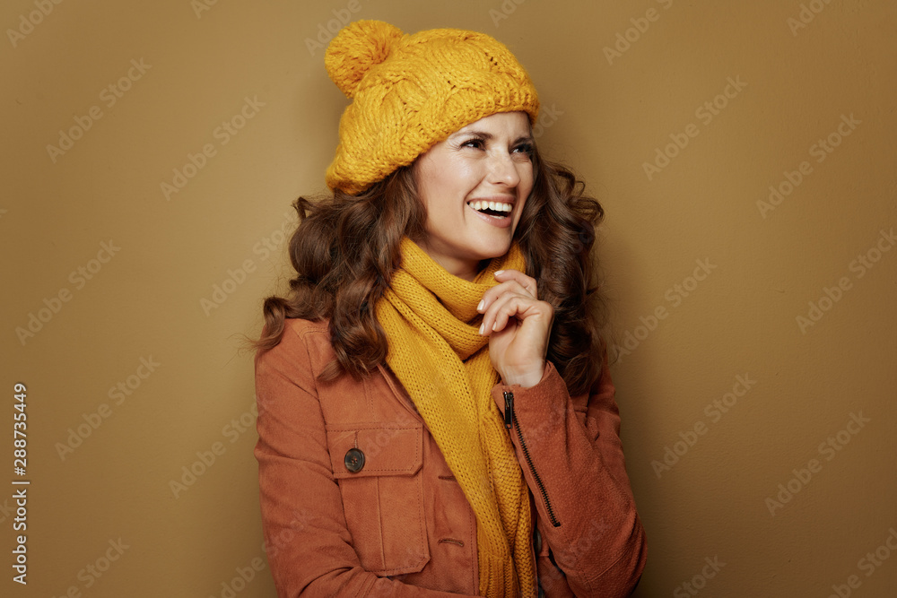 happy elegant woman looking aside isolated on beige happy elegant woman looking aside isolated on beige