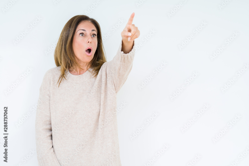 Beautiful middle age woman over isolated background Pointing with finger surprised ahead, open mouth amazed expression, something in front Beautiful middle age woman over isolated background Pointing with finger surprised ahead, open mouth amazed expression, something in front