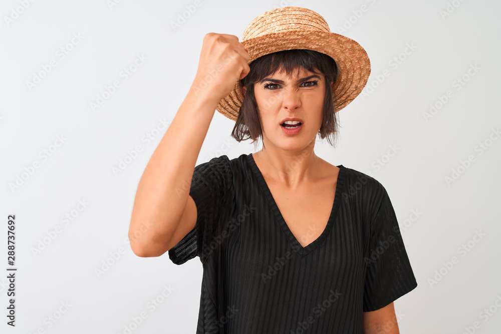 Young beautiful woman wearing black t-shirt and hat standing over isolated white background annoyed and frustrated shouting with anger, crazy and yelling with raised hand, anger concept Young beautiful woman wearing black t-shirt and hat standing over isolated white background annoyed and frustrated shouting with anger, crazy and yelling with raised hand, anger concept