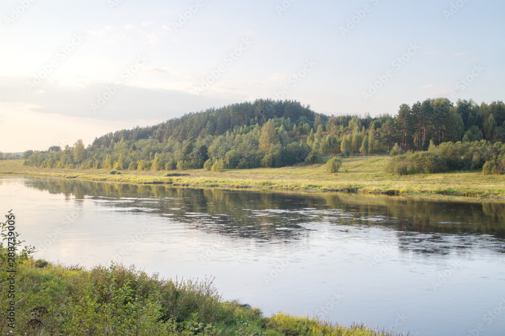 Obraz premium by the river in the countryside on a summer evening