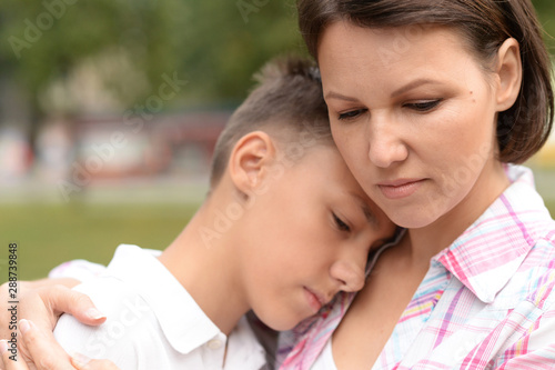 Close up portrait of sad mother with son