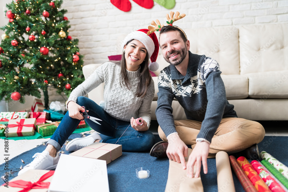 Portrait Of Couple Preparing Christmas Gifts At Home Portrait Of Couple Preparing Christmas Gifts At Home