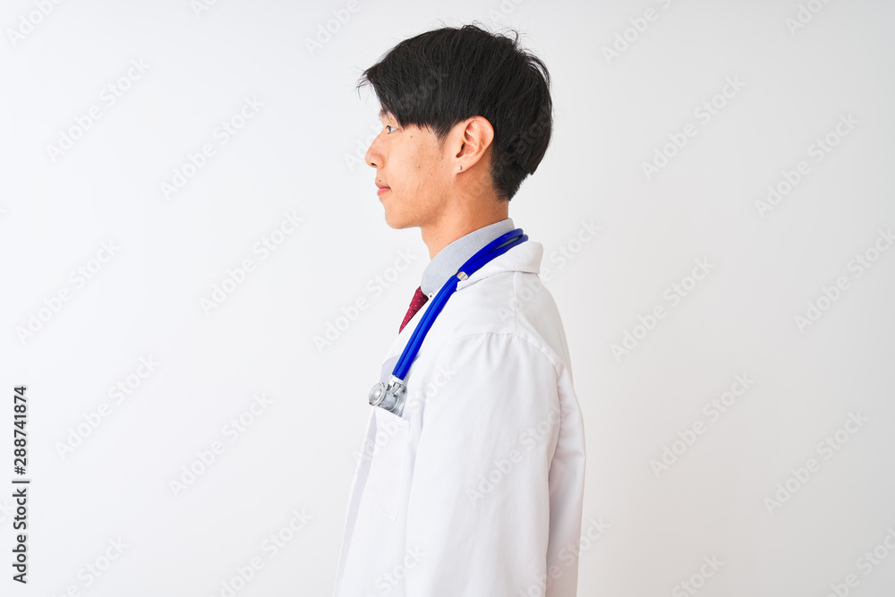 Chinese doctor man wearing coat tie and stethoscope over isolated white background looking to side, relax profile pose with natural face with confident smile. Chinese doctor man wearing coat tie and stethoscope over isolated white background looking to side, relax profile pose with natural face with confident smile.