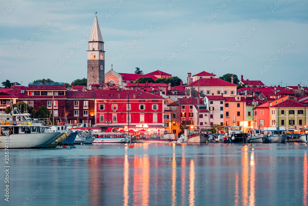 Attractive evening cityscape of old fishing town Isola. Colorful spring seascape of Adriatic Sea. Beautiful outdoor scene of Slovenia, Europe. Traveling concept background.