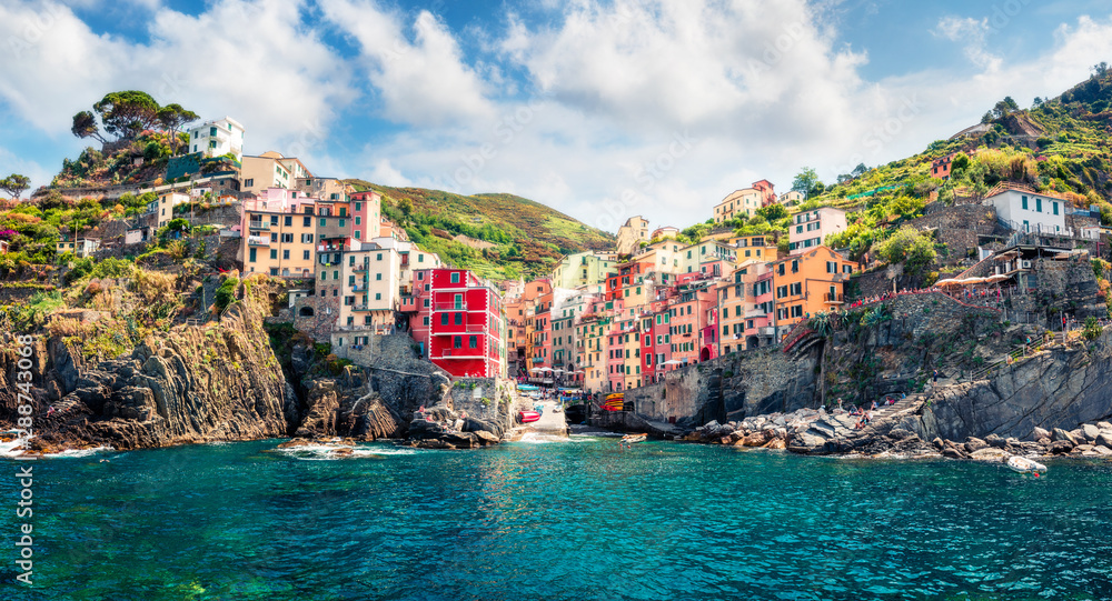First city of the Cique Terre sequence of hill cities - Riomaggiore. Sunny morning view of Liguria, Italy, Europe. Splendid spring seascape of Mediterranean sea. Traveling concept background.