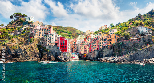 First city of the Cique Terre sequence of hill cities - Riomaggiore. Sunny morning view of Liguria, Italy, Europe. Splendid spring seascape of Mediterranean sea. Traveling concept background. photo