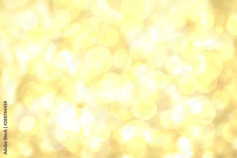 A festive abstract delicate golden yellow gradient background texture with glitter defocused sparkle bokeh circles. Card concept for Happy New Year, party invitation, valentine or other holidays.
