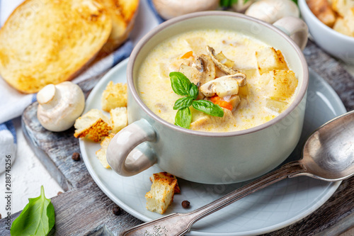 Saucepan with chicken cream soup with mushrooms.