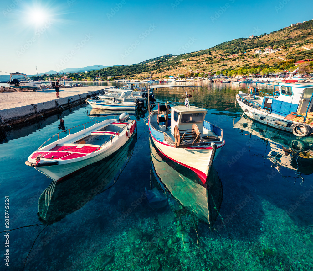 Sunny morning view of Agios Nikolaos, small port on the island of Zakynthos, Greece, Europe. Colorful summer seascape of Ionian sea. Traveling concept background.