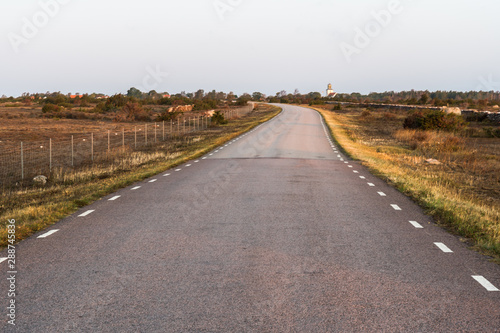 Morning sunshine at a country road in a barren grassland