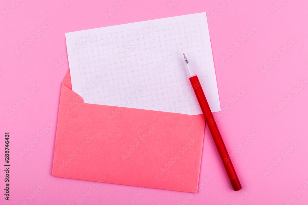 A white sheet of paper for drawings, texts, letters and notes, next to a red pen and envelope for letters lies on a pink background A white sheet of paper for drawings, texts, letters and notes, next to a red pen and envelope for letters lies on a pink background