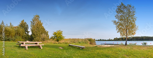 Panoramic view on public resting and swimming area on a riverside beach, Europe