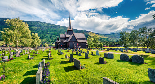 Attractive summer view of Lom stave church (Lom Stavkyrkje). Sunny morning scene of Norwegian countryside, administrative centre of Lom municipality - Fossbergom, Norway, Europe. photo