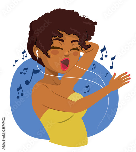 Happy black teenager woman listening to music with earphones and dancing