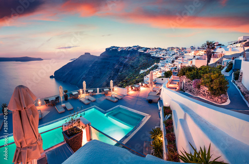 Fantastic evening view of Santorini island. Picturesque spring sunset on famous Greek resort Fira, Greece, Europe. Traveling concept background. Artistic style post processed photo.
