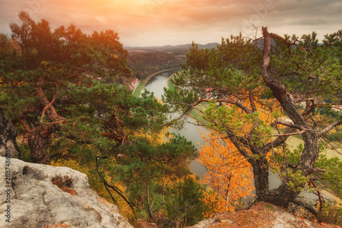 Colorful autumn landscape in the Saxony Bastei Mountains national park. View of exposed sandstone rocks and forest hilly. Dresden. Concept of outdoor recreation in natural settings out of town. 