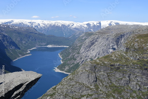 The world-famous stone ledge on Mount Skigedal, in Norway, rises above Lake Ringedalsvatn