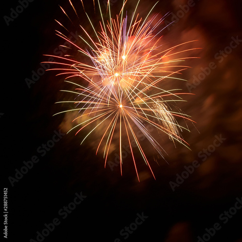 Red fireworks on black night sky background