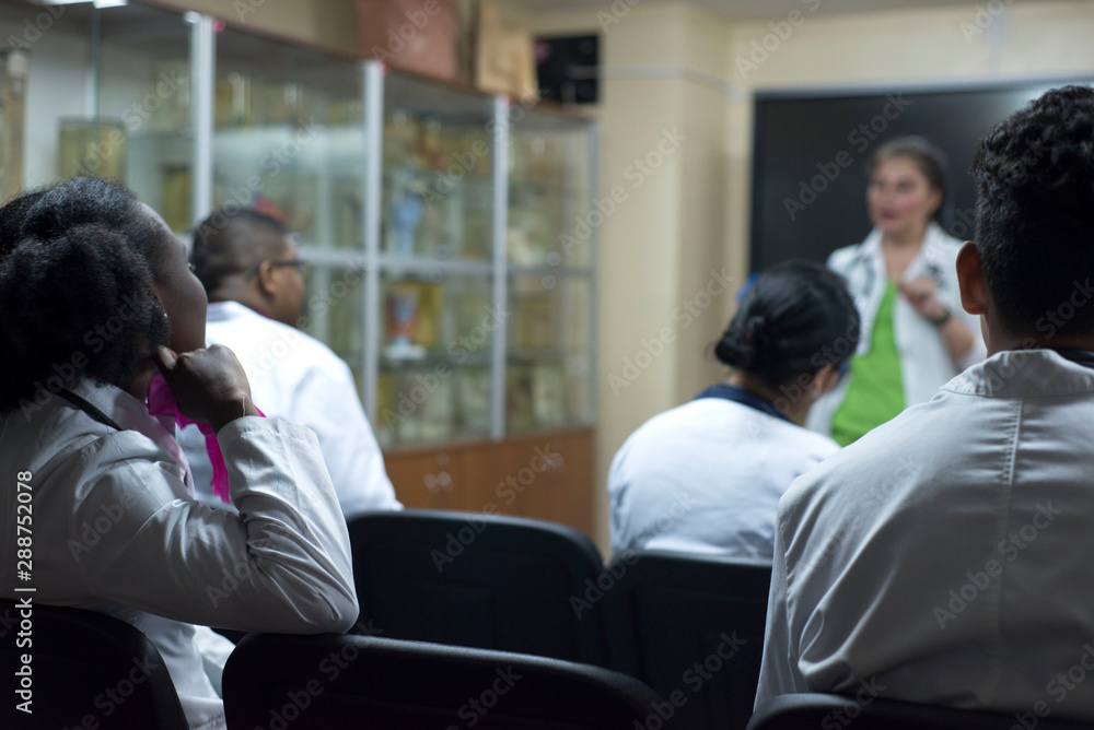 a group of mixed race doctors. At the medical conference ask questions, raise your hand from the hall a group of mixed race doctors. At the medical conference ask questions, raise your hand from the hall