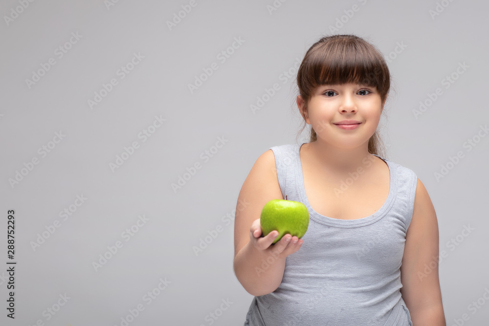 overweight girl with a green Apple . proper diet overweight girl with a green Apple . proper diet