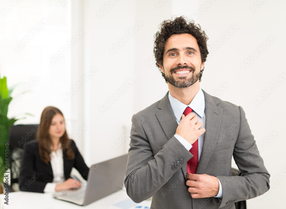 Portrait of an handsome businessman adjusting his tie Portrait of an handsome businessman adjusting his tie