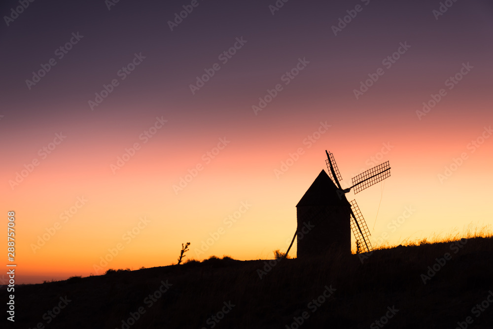 Old windmill at sunset