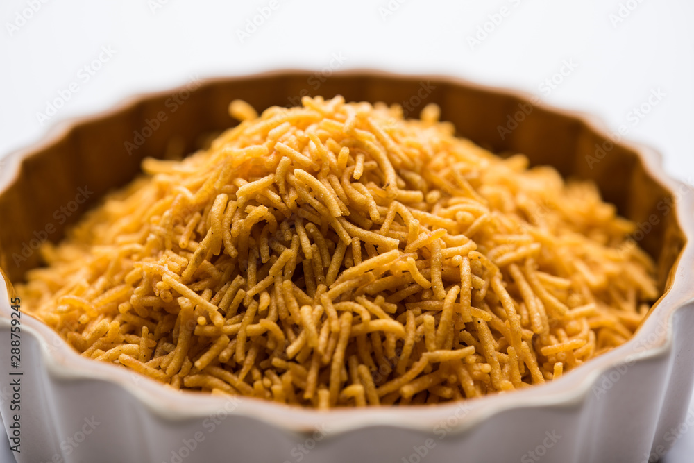 Aloo Bhujiya or Potato Bhujia also known as Namkeen sev. Popular Bikaneri recipe served in a bowl or plate. selective focus Aloo Bhujiya or Potato Bhujia also known as Namkeen sev. Popular Bikaneri recipe served in a bowl or plate. selective focus