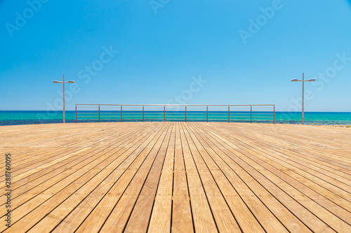 Light wooden platform on the sea coast on a summer day at the Cyprus coast.