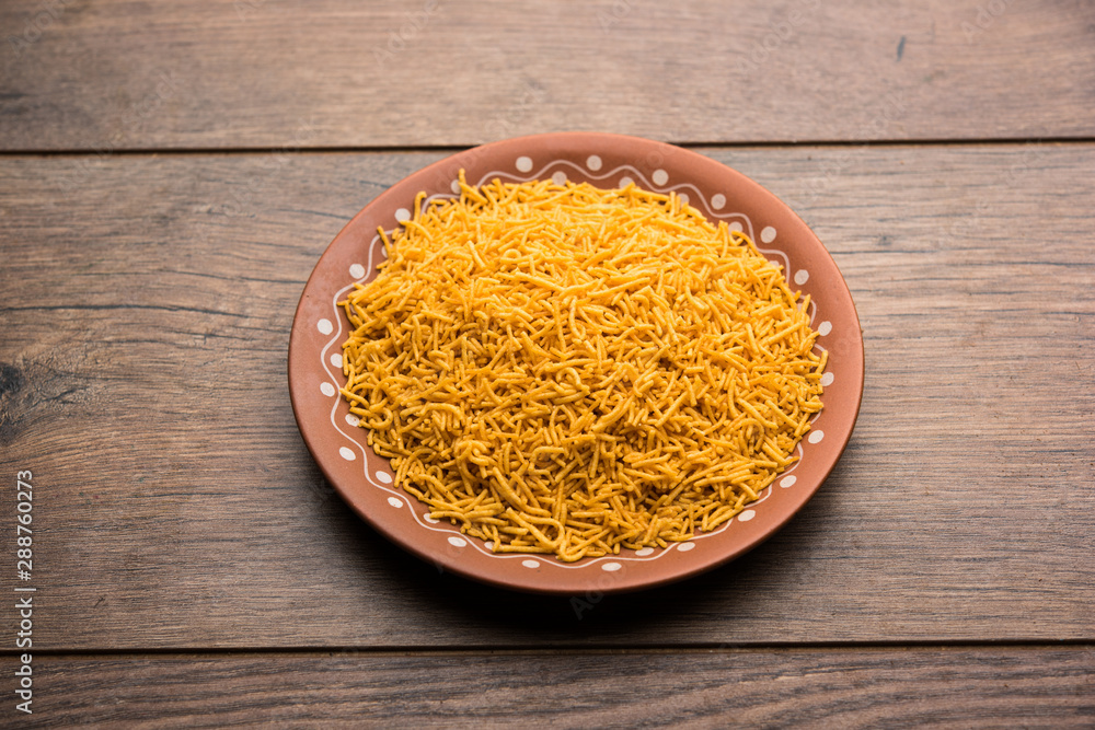 Aloo Bhujiya or Potato Bhujia also known as Namkeen sev. Popular Bikaneri recipe served in a bowl or plate. selective focus Aloo Bhujiya or Potato Bhujia also known as Namkeen sev. Popular Bikaneri recipe served in a bowl or plate. selective focus