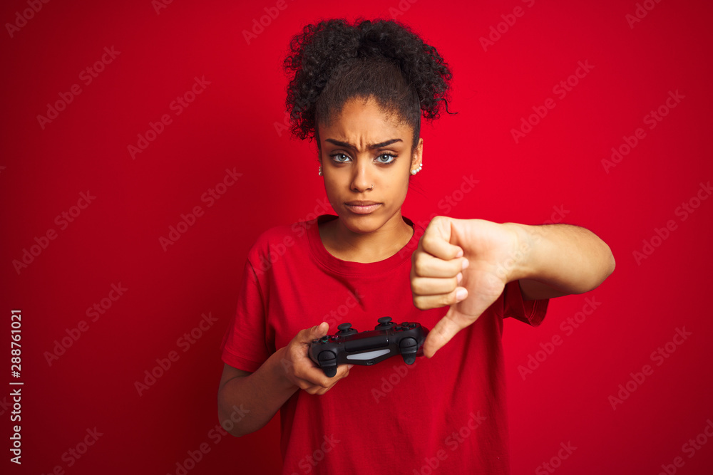 African american gamer woman playing video game using joystick over ...