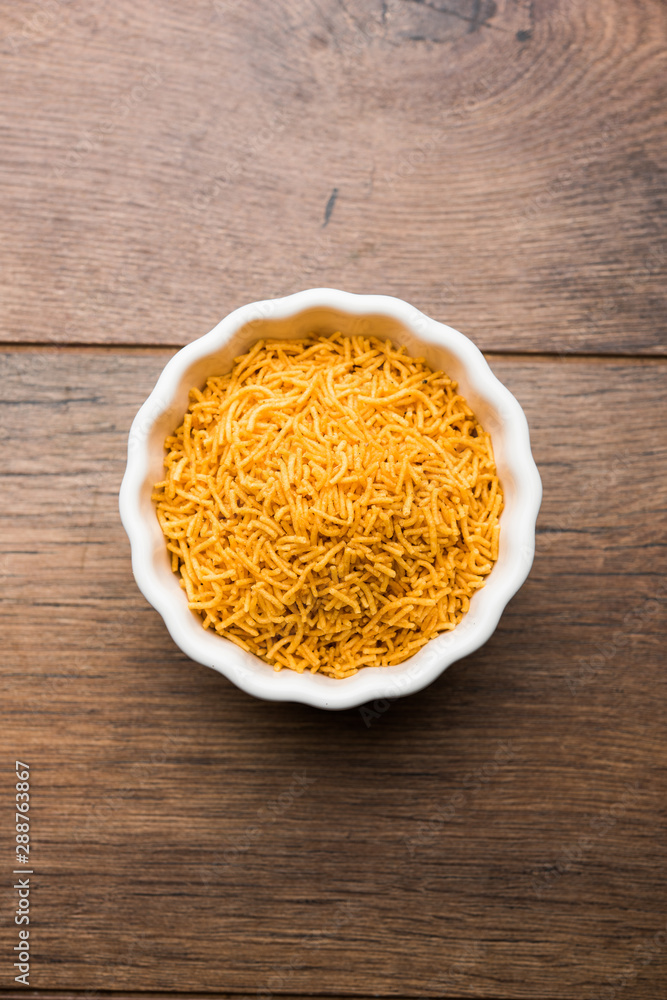 Aloo Bhujiya or Potato Bhujia also known as Namkeen sev. Popular Bikaneri recipe served in a bowl or plate. selective focus Aloo Bhujiya or Potato Bhujia also known as Namkeen sev. Popular Bikaneri recipe served in a bowl or plate. selective focus