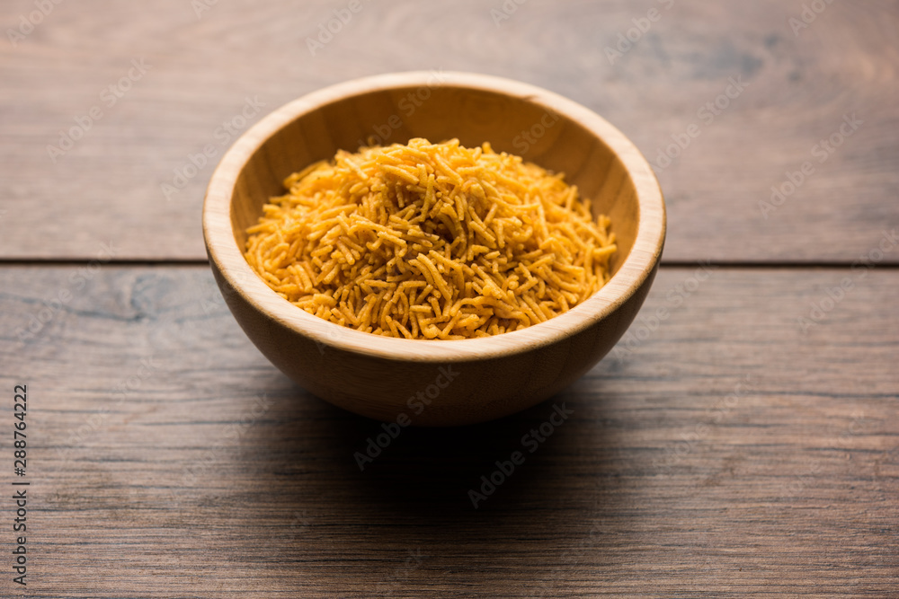 Aloo Bhujiya or Potato Bhujia also known as Namkeen sev. Popular Bikaneri recipe served in a bowl or plate. selective focus Aloo Bhujiya or Potato Bhujia also known as Namkeen sev. Popular Bikaneri recipe served in a bowl or plate. selective focus