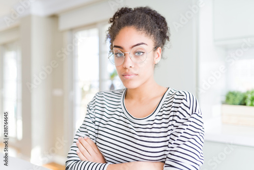 Free Download Beautiful young african american woman with afro hair wearing glasses Relaxed with serious expression on face. Simple and natural with crossed arms - GFXLoad