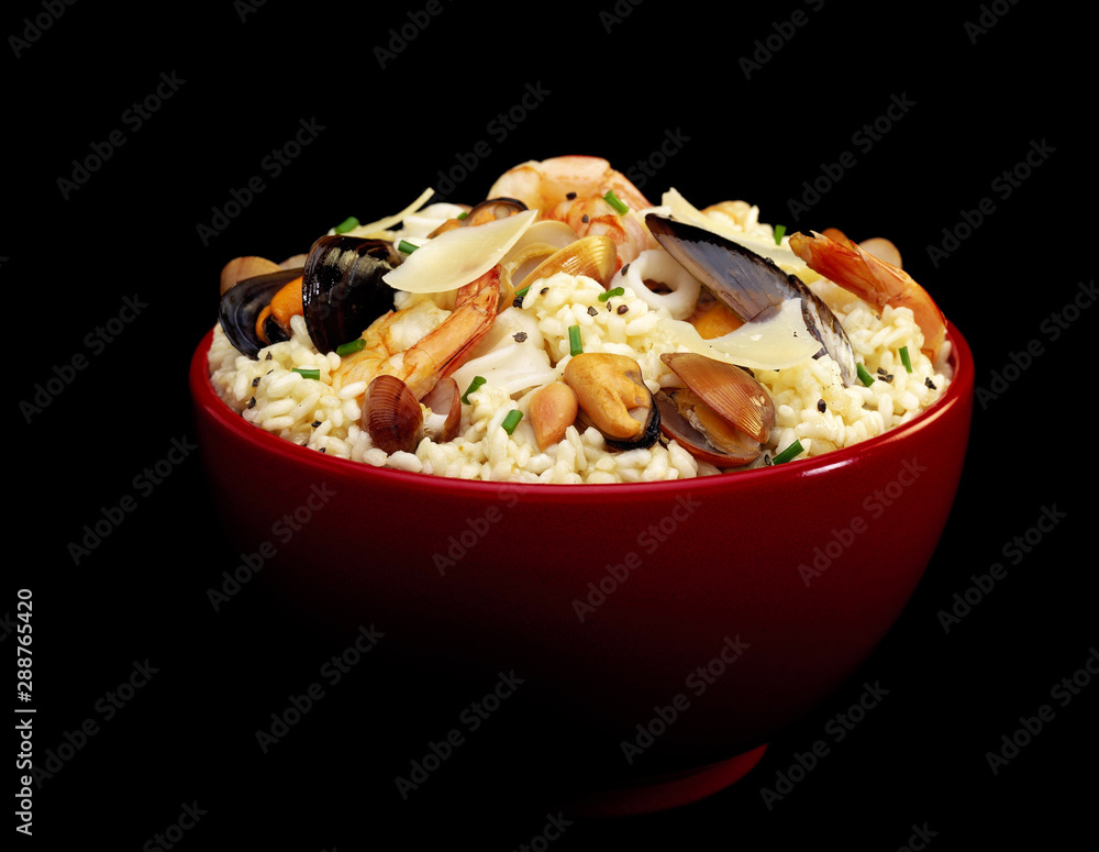 Various Seafoods on Rice in red bowl against black background Various Seafoods on Rice in red bowl against black background