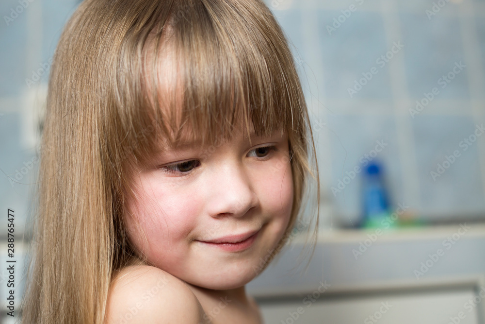 Pretty girl face portrait, smiling child with beautiful eyes and long wet fair hair on blurred background of bathroom. Pretty girl face portrait, smiling child with beautiful eyes and long wet fair hair on blurred background of bathroom.