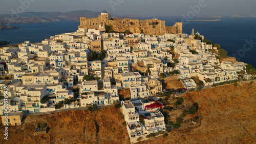 Aerial drone photo of iconic medieval fortified castle overlooking the deep blue Aegean sea in Chora of Astypalaia island, Dodecanese islands, Greece