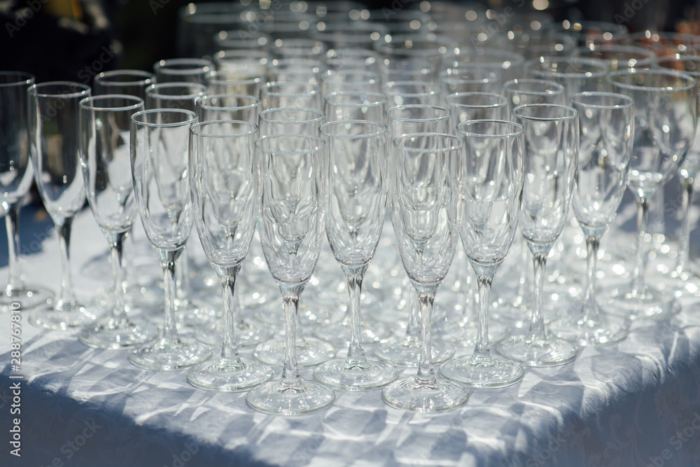 A row of empty champagne glasses on table. Banquet setting A row of empty champagne glasses on table. Banquet setting