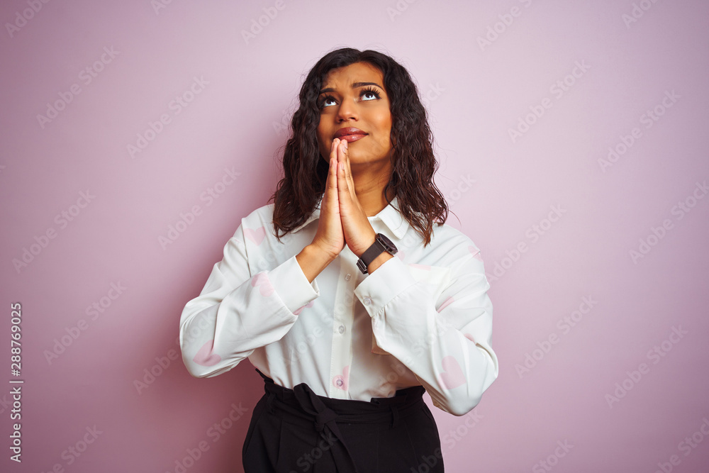 Transsexual transgender businesswoman standing over isolated pink background begging and praying with hands together with hope expression on face very emotional and worried. Asking for forgiveness. Transsexual transgender businesswoman standing over isolated pink background begging and praying with hands together with hope expression on face very emotional and worried. Asking for forgiveness.