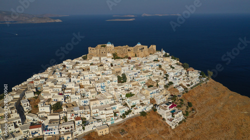 Aerial drone photo of iconic medieval fortified castle overlooking the deep blue Aegean sea in Chora of Astypalaia island, Dodecanese islands, Greece