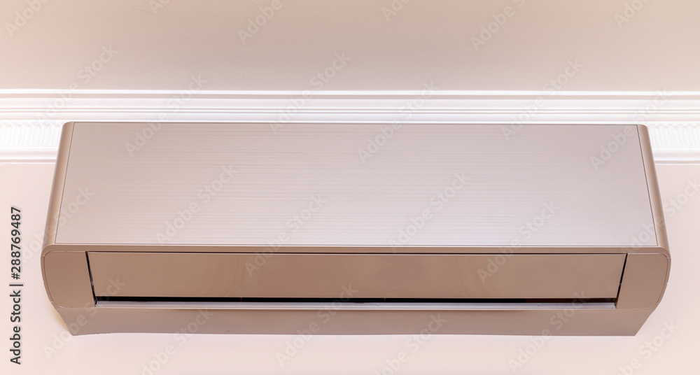Gold air conditioner on the wall in room. Gold air conditioner on the wall in room.