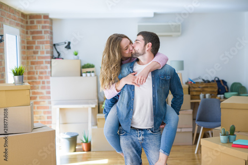 Young couple moving to a new house, boyfriend giving a piggy back ride to girlfriend, very happy and cheerful for new apartment © Krakenimages.com