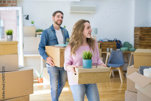 Young beautiful couple very happy together holding cardboard boxes moving to a new home © Krakenimages.com