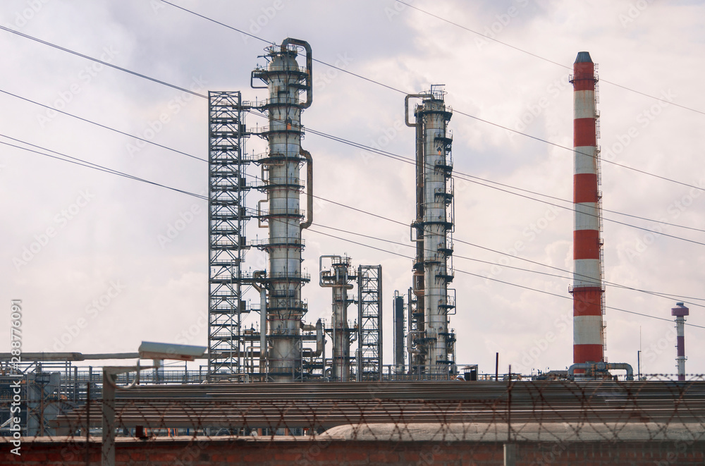 View of tall oil refinery pipes in summer on a clear day View of tall oil refinery pipes in summer on a clear day