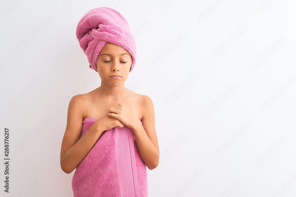 Beautiful child girl wearing shower towel after bath standing over isolated white background depressed and worry for distress, crying angry and afraid. Sad expression.