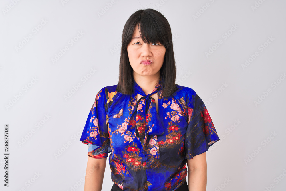 Young beautiful chinese woman wearing summer floral t-shirt over isolated white background depressed and worry for distress, crying angry and afraid. Sad expression. Young beautiful chinese woman wearing summer floral t-shirt over isolated white background depressed and worry for distress, crying angry and afraid. Sad expression.