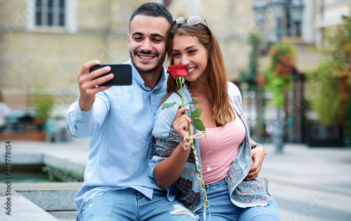 Happy couple making a selfie with mobile phone. Dating, love, relationships, lifestyle concept