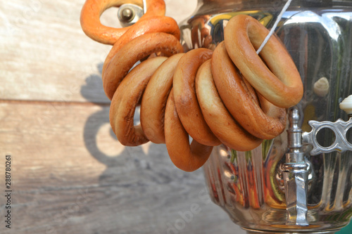 Traditional russian old samovar with tasty bagels photo