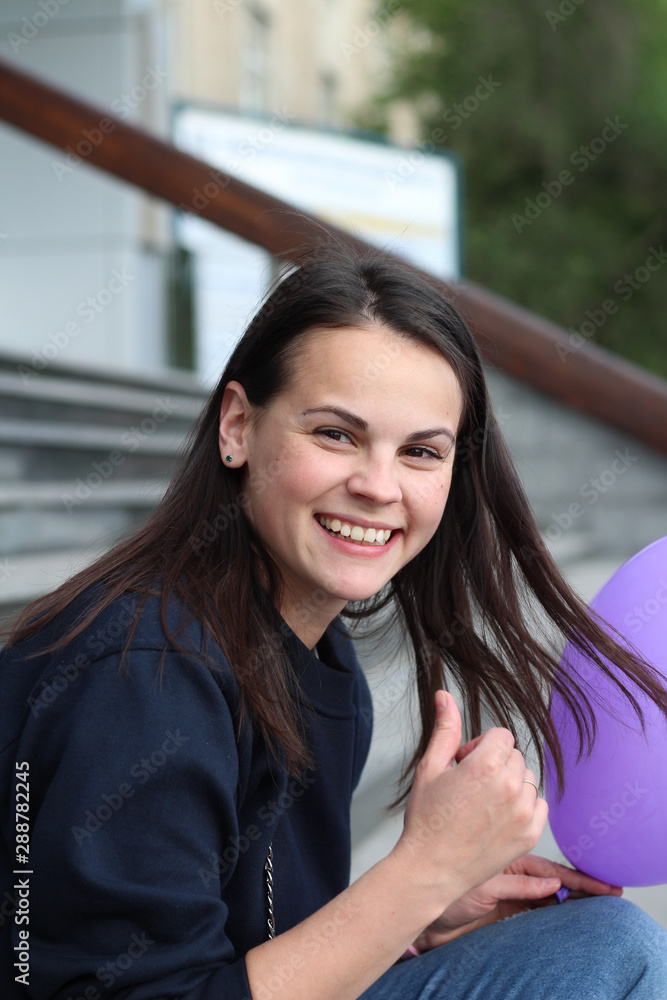 cute smiling white brunette girl sitting on the steps cute smiling white brunette girl sitting on the steps